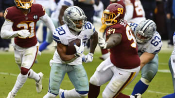 Oct 25, 2020; Landover, Maryland, USA; Dallas Cowboys running back Tony Pollard (20) rushes the ball as Washington Football Team defensive tackle Tim Settle (97) defends during the second half at FedExField. Mandatory Credit: Brad Mills-USA TODAY Sports