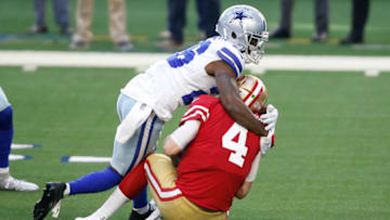 Dec 20, 2020; Arlington, Texas, USA; Dallas Cowboys cornerback Jourdan Lewis (26) sacks San Francisco 49ers quarterback Nick Mullens (4) in the second quarter at AT&T Stadium. Mandatory Credit: Tim Heitman-USA TODAY Sports