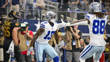 Oct 2, 2022; Arlington, Texas, USA; Dallas Cowboys wide receiver Michael Gallup (13) and wide receiver CeeDee Lamb (88) celebrate after Gallup catches a pass for a touchdown against the Washington Commanders during the second quarter at AT&T Stadium. Mandatory Credit: Jerome Miron-USA TODAY Sports