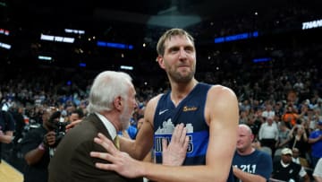 SAN ANTONIO, TX - APRIL 10: Dirk Nowitzki #41 of the Dallas Mavericks talks with Head Coach Gregg Popovich of the San Antonio Spurs after the game on April 10, 2019 at the AT&T Center in San Antonio, Texas. NOTE TO USER: User expressly acknowledges and agrees that, by downloading and or using this photograph, user is consenting to the terms and conditions of the Getty Images License Agreement. Mandatory Copyright Notice: Copyright 2019 NBAE (Photos by Darren Carroll/NBAE via Getty Images)