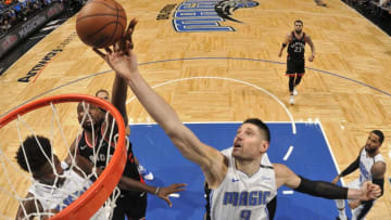 ORLANDO, FL - DECEMBER 28: Nikola Vucevic #9 of the Orlando Magic and Serge Ibaka #9 of the Toronto Raptors reach for the rebound during the game on December 28, 2018 at Amway Center in Orlando, Florida. NOTE TO USER: User expressly acknowledges and agrees that, by downloading and or using this photograph, User is consenting to the terms and conditions of the Getty Images License Agreement. Mandatory Copyright Notice: Copyright 2018 NBAE (Photo by Fernando Medina/NBAE via Getty Images)