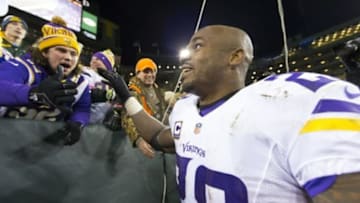 Jan 3, 2016; Green Bay, WI, USA; Minnesota Vikings running back Adrian Peterson (28) celebrates with fans following during the game against the Green Bay Packers at Lambeau Field. Minnesota won 20-13. Mandatory Credit: Jeff Hanisch-USA TODAY Sports