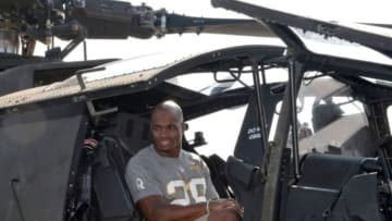 Jan 27, 2016; Wahiawa, HI, USA; Minnesota Vikings running back Adrian Peterson poses in a Boeing AH-64 Apache helicopter during the 2016 Pro Bowl Draft at Wheeler Army Airfield. Mandatory Credit: Kirby Lee-USA TODAY Sports