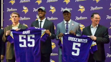 May 9, 2014; Eden Prairie, MN, USA; Minnesota Vikings general manager Rick Spielman (left), linebacker Anthony Barr, quarterback Teddy Bridgewater, and head coach Mike Zimmer (right) pose for pictures at Winter Park Fieldhouse. Mandatory Credit: Brad Rempel-USA TODAY Sports