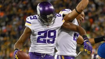 Jan 3, 2016; Green Bay, WI, USA; Minnesota Vikings cornerback Xavier Rhodes (29) celebrates with cornerback Josh Robinson (21) after intercepting a pass in the fourth quarter during the game against the Green Bay Packers at Lambeau Field. Mandatory Credit: Benny Sieu-USA TODAY Sports
