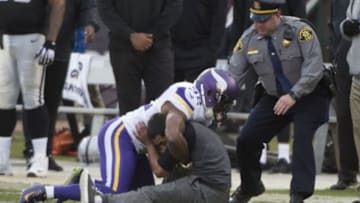 November 15, 2015; Oakland, CA, USA; Minnesota Vikings cornerback Antone Exum (32) tackles a trespasser during the fourth quarter against the Oakland Raiders at O.co Coliseum. The Vikings defeated the Raiders 30-14. Mandatory Credit: Kyle Terada-USA TODAY Sports