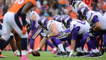 Oct 4, 2015; Denver, CO, USA; Minnesota Vikings center Joe Berger (61) prepares to hike to Minnesota Vikings quarterback Teddy Bridgewater (5) in the in second half against the Denver Broncos at Sports Authority Field at Mile High. The Broncos defeated the Vikings 23-20. Mandatory Credit: Ron Chenoy-USA TODAY Sports