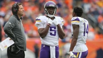 Oct 4, 2015; Denver, CO, USA; Minnesota Vikings quarterback Teddy Bridgewater (5) talks with Minnesota Vikings quarterbacks coach Scott Turner (left) and wide receiver Stefon Diggs (14) during the first half against the Denver Broncos at Sports Authority Field at Mile High. Mandatory Credit: Chris Humphreys-USA TODAY Sports
