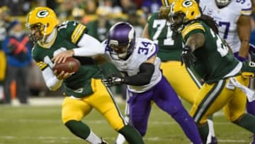 Jan 3, 2016; Green Bay, WI, USA; Minnesota Vikings safety Andrew Sendejo (34) puts pressure on Green Bay Packers quarterback Aaron Rodgers (12) in the first quarter at Lambeau Field. Mandatory Credit: Benny Sieu-USA TODAY Sports