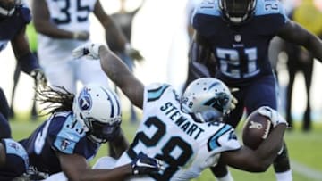 Nov 15, 2015; Nashville, TN, USA; Carolina Panthers running back Jonathan Stewart (28) reaches for extra yardage as he is tackled by Tennessee Titans free safety Michael Griffin (33) during the second half at Nissan Stadium. The Panthers won 27-10. Mandatory Credit: Christopher Hanewinckel-USA TODAY Sports