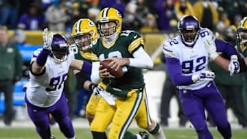 Jan 3, 2016; Green Bay, WI, USA; Green Bay Packers quarterback Aaron Rodgers (12) scrambles away from Minnesota Vikings defensive end Brian Robison (96) in the fourth quarter at Lambeau Field. Mandatory Credit: Benny Sieu-USA TODAY Sports