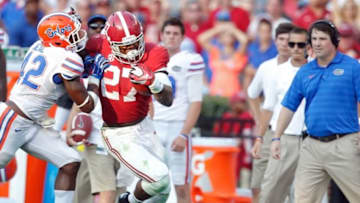 Sep 20, 2014; Tuscaloosa, AL, USA; Alabama Crimson Tide running back Derrick Henry (27) pushes away Florida Gators defensive back Keanu Neal (42) at Bryant-Denny Stadium. Mandatory Credit: Marvin Gentry-USA TODAY Sports