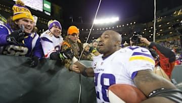 Jan 3, 2016; Green Bay, WI, USA; Minnesota Vikings running back Adrian Peterson (28) celebrates with fans following during the game against the Green Bay Packers at Lambeau Field. Minnesota won 20-13. Mandatory Credit: Jeff Hanisch-USA TODAY Sports