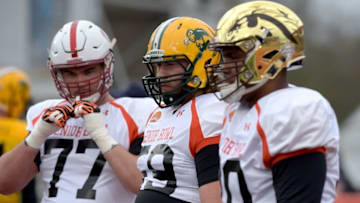 Jan 26, 2016; Mobile, AL, USA; North squad offensive tackle Joe Haeg of North Dakota State (middle) listens to instructions from a member of the Dallas Cowboys coaching staff with offensive tackle Kyle Murphy of Stanford (77) and offensive guard Willie Beavers of Western Michigan (right) during Senior Bowl practice at Ladd-Peebles Stadium. Mandatory Credit: Glenn Andrews-USA TODAY Sports