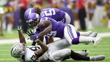 MINNEAPOLIS, MINNESOTA - SEPTEMBER 22: Darren Waller #83 of the Oakland Raiders loses the ball as Xavier Rhodes #29 and Eric Kendricks #54 of the Minnesota Vikings tackle him during the third quarter of the game at U.S. Bank Stadium on September 22, 2019 in Minneapolis, Minnesota. The ball was ruled down on the play. (Photo by Hannah Foslien/Getty Images)