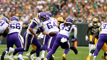 GREEN BAY, WISCONSIN - SEPTEMBER 15: Quarterback Kirk Cousins #8 hands off to teammate Running back Dalvin Cook #33 of the Minnesota Vikings against the Green Bay Packers in the first quarter during the game at Lambeau Field on September 15, 2019 in Green Bay, Wisconsin. (Photo by Dylan Buell/Getty Images)