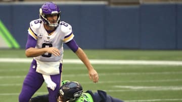 SEATTLE, WASHINGTON - OCTOBER 11: Kirk Cousins #8 of the Minnesota Vikings is pressured by Poona Ford #97 of the Seattle Seahawks during the first quarter at CenturyLink Field on October 11, 2020 in Seattle, Washington. (Photo by Abbie Parr/Getty Images)