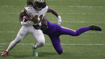 NEW ORLEANS, LOUISIANA - DECEMBER 25: Alvin Kamara #41 of the New Orleans Saints makes a reception past Jeff Gladney #20 of the Minnesota Vikings during the fourth quarter at Mercedes-Benz Superdome on December 25, 2020 in New Orleans, Louisiana. (Photo by Chris Graythen/Getty Images)