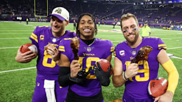 Nov 24, 2022; Minneapolis, Minnesota, USA; Minnesota Vikings quarterback Kirk Cousins (8), wide receiver Justin Jefferson (18), and wide receiver Adam Thielen (19) celebrate the win against the New England Patriots after the game at U.S. Bank Stadium. Mandatory Credit: Matt Krohn-USA TODAY Sports