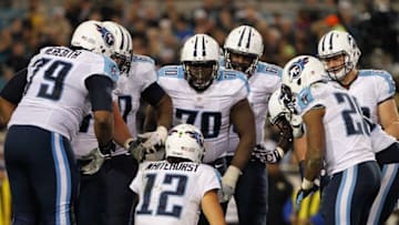 Dec 18, 2014; Jacksonville, FL, USA; Tennessee Titans quarterback Charlie Whitehurst (12) huddles up with the offense against the Jacksonville Jaguars during the second half at EverBank Field. Jacksonville Jaguars defeated the Tennessee Titans 21-13. Mandatory Credit: Kim Klement-USA TODAY Sports