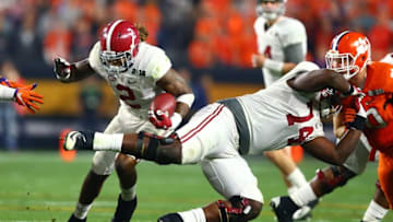 Jan 11, 2016; Glendale, AZ, USA; Alabama Crimson Tide running back Derrick Henry (2) runs the ball as offensive lineman Cam Robinson (74) blocks a Clemson Tigers defender in the 2016 CFP National Championship at University of Phoenix Stadium. Mandatory Credit: Mark J. Rebilas-USA TODAY Sports