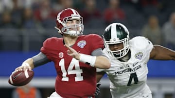 Dec 31, 2015; Arlington, TX, USA; Alabama Crimson Tide quarterback Jake Coker (14) is pressured by Michigan State Spartans defensive lineman Malik McDowell (4) in the third quarter in the 2015 CFP semifinal at the Cotton Bowl at AT&T Stadium. Mandatory Credit: Tim Heitman-USA TODAY Sports