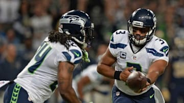 Sep 13, 2015; St. Louis, MO, USA; Seattle Seahawks quarterback Russell Wilson (3) hands off to running back Marshawn Lynch (24) during the first half against the St. Louis Rams at the Edward Jones Dome. The Rams defeated the Seahawks 34-31 in overtime. Mandatory Credit: Jeff Curry-USA TODAY Sports