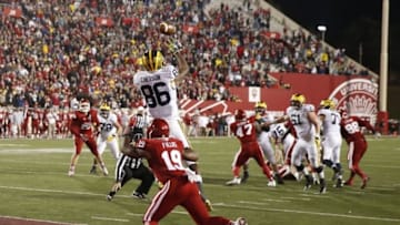 Nov 14, 2015; Bloomington, IN, USA; Michigan Wolverines wide receiver Jehu Chesson (86) catches a touchdown pass on the last play of the 4th quarter to send the game into overtime against Indiana Hoosiers safety Tony Fields (19) at Memorial Stadium. Michigan defeats Indiana in double overtime 48-41. Mandatory Credit: Brian Spurlock-USA TODAY Sports