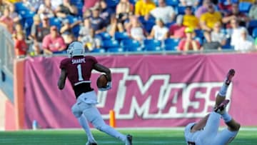 Aug 30, 2014; Foxborough, MA, USA; Massachusetts Minutemen wide receiver Tajae Sharpe (1) breaks the tackle of Boston College Eagles defensive back Sean Sylvia (19) and runs for a touchdown during the second half at Gillette Stadium. Mandatory Credit: Bob DeChiara-USA TODAY Sports