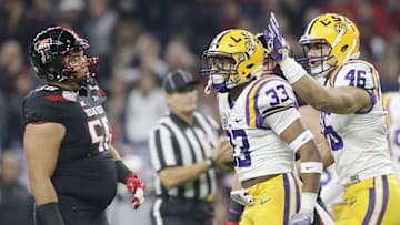 Dec 29, 2015; Houston, TX, USA; LSU Tigers defensive end Tashawn Bower (46) celebrates LSU Tigers safety Jamal Adams (33) defensive play against the Texas Tech Red Raiders in the first quarter at NRG Stadium. Mandatory Credit: Thomas B. Shea-USA TODAY Sports