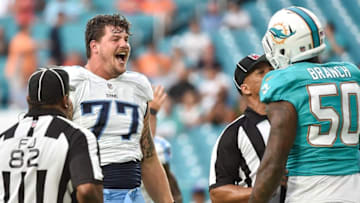 Sep 1, 2016; Miami Gardens, FL, USA; Tennessee Titans tackle Taylor Lewan (77) laughs at Miami Dolphins defensive end Andre Branch (50) during the first half against the at Hard Rock Stadium. Mandatory Credit: Steve Mitchell-USA TODAY Sports