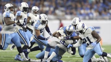 Sep 18, 2016; Detroit, MI, USA; Detroit Lions running back Theo Riddick (25) gets tackled by Tennessee Titans linebacker Kevin Dodd (behind) and inside linebacker Avery Williamson (behind 21) during the fourth quarter at Ford Field. Titans win 16-15. Mandatory Credit: Raj Mehta-USA TODAY Sports