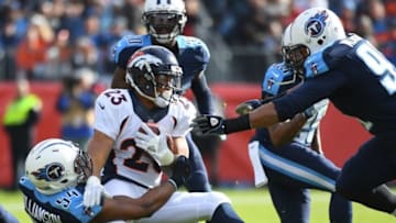 Dec 11, 2016; Nashville, TN, USA; Denver Broncos running back Devontae Booker (23) is tackled by Tennessee Titans linebacker Avery Williamson (54) during the first half at Nissan Stadium. Mandatory Credit: Christopher Hanewinckel-USA TODAY Sports
