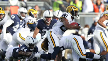 Nov 21, 2015; University Park, PA, USA; Michigan Wolverines cornerback Jourdan Lewis (26) runs with the ball on a punt return during the fourth quarter against the Penn State Nittany Lions at Beaver Stadium. Michigan defeated Penn State 28-16. Mandatory Credit: Matthew O