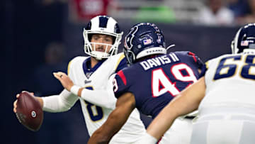 HOUSTON, TX - AUGUST 29: Brandon Allen #8 of the Los Angeles Rams tries to avoid the rush of Jamal Davis II #49 of the Houston Texans during week four of the preseason at NRG Stadium on August 29, 2019 in Houston, Texas. (Photo by Wesley Hitt/Getty Images)