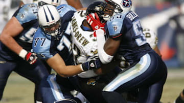 Titan defenders Keith Bulluck (r) and Sean Conover make a tackle on Maurice Jones-Drew during 1st-half action between the Jacksonville Jaguars and Tennessee Titans at LP Field in Nashville, Tennessee on December 17, 2006. Tennessee won 24-17. (Photo by Joe Murphy/NFLPhotoLibrary)