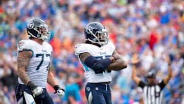 NASHVILLE, TN - OCTOBER 06: Derrick Henry #22 of the Tennessee Titans celebrates a third quarter touchdown with Taylor Lewan #77 against the Buffalo Bills at Nissan Stadium on October 6, 2019 in Nashville, Tennessee. Buffalo defeats Tennessee 14-7. (Photo by Brett Carlsen/Getty Images)
