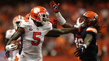 SYRACUSE, NEW YORK - SEPTEMBER 14: Tee Higgins #5 of the Clemson Tigers grabs Lakiem Williams #46 of the Syracuse Orange's face mask during a game at the Carrier Dome on September 14, 2019 in Syracuse, New York. (Photo by Bryan M. Bennett/Getty Images)