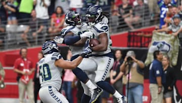 GLENDALE, ARIZONA - SEPTEMBER 29: Jadeveon Clowney #90 of the Seattle Seahawks celebrates with Branden Jackson #93 after scoring a touchdown on an interception return during the first quarter of a game against the Arizona Cardinals at State Farm Stadium on September 29, 2019 in Glendale, Arizona. (Photo by Norm Hall/Getty Images)