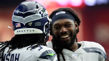 GLENDALE, ARIZONA - SEPTEMBER 29: Outside linebacker Jadeveon Clowney #90 of the Seattle Seahawks shares a laugh with defensive end Ezekiel Ansah #94 during the NFL game against the Arizona Cardinalsat State Farm Stadium on September 29, 2019 in Glendale, Arizona. The Seattle Seahawks won 27-10. (Photo by Jennifer Stewart/Getty Images)