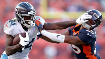 DENVER, COLORADO - OCTOBER 13: Corey Davis #84 of the Tennessee Titans stiff arms Chris Harris Jr #25 of the Denver Broncos after making a reception in the fourth quarter at Broncos Stadium at Mile High on October 13, 2019 in Denver, Colorado. (Photo by Matthew Stockman/Getty Images)