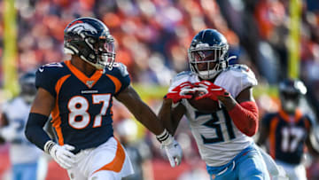 DENVER, CO - OCTOBER 13: Kevin Byard #31 of the Tennessee Titans intercepts a pass intended for Noah Fant #87 of the Denver Broncos in the third quarter of a game at Empower Field at Mile High on October 13, 2019 in Denver, Colorado. (Photo by Dustin Bradford/Getty Images)