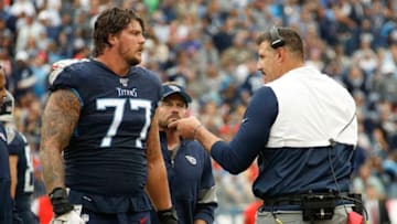 NASHVILLE, TENNESSEE - OCTOBER 27: Head coach Mike Vrabel of the Tennessee Titans speaks to Taylor Lewan #77 during the second half of a game against the Tampa Bay Buccaneers at Nissan Stadium on October 27, 2019 in Nashville, Tennessee. (Photo by Frederick Breedon/Getty Images)