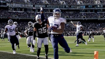 OAKLAND, CALIFORNIA - DECEMBER 08: Derrick Henry #22 of the Tennessee Titans carries the ball for a 12 yard touchdown run against the Oakland Raiders during the first half of an NFL football game at RingCentral Coliseum on December 08, 2019 in Oakland, California. (Photo by Thearon W. Henderson/Getty Images)