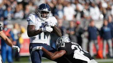 OAKLAND, CALIFORNIA - DECEMBER 08: A.J. Brown #11 of the Tennessee Titans breaks a tackle by Daryl Worley #20 of the Oakland Raiders to score a touchdown in the second quarter at RingCentral Coliseum on December 08, 2019 in Oakland, California. (Photo by Lachlan Cunningham/Getty Images)