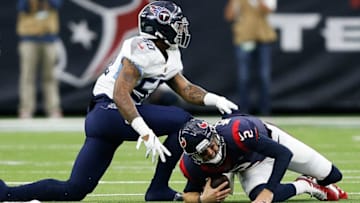 HOUSTON, TEXAS - DECEMBER 29: AJ McCarron #2 of the Houston Texans is sacked by Derick Roberson #50 of the Tennessee Titans during the first half at NRG Stadium on December 29, 2019 in Houston, Texas. (Photo by Bob Levey/Getty Images)