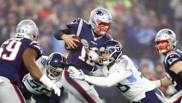 FOXBOROUGH, MASSACHUSETTS - JANUARY 04: Tom Brady #12 of the New England Patriots looks to pass as he is hit by Harold Landry #58 of the Tennessee Titans in the first quarter of the AFC Wild Card Playoff game at Gillette Stadium on January 04, 2020 in Foxborough, Massachusetts. (Photo by Maddie Meyer/Getty Images)