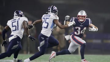 FOXBOROUGH, MASSACHUSETTS - JANUARY 04: Jonathan Jones #31 of the New England Patriots catches and carries for a first down against Adoree' Jackson #25 and David Long #51 of the Tennessee Titans in the second quarter of the AFC Wild Card Playoff game at Gillette Stadium on January 04, 2020 in Foxborough, Massachusetts. (Photo by Elsa/Getty Images)