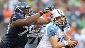 SEATTLE - AUGUST 14: Quarterback Chris Simms #11 of the Tennessee Titans is sacked during the preseason game by Red Bryant #79 of the Seattle Seahawks at Qwest Field on August 14, 2010 in Seattle, Washington. (Photo by Otto Greule Jr/Getty Images)