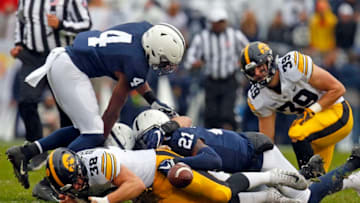 STATE COLLEGE, PA - OCTOBER 27: T.J. Hockenson #38 of the Iowa Hawkeyes fumbles against Amani Oruwariye #21 and Nick Scott #4 of the Penn State Nittany Lions on October 27, 2018 at Beaver Stadium in State College, Pennsylvania. (Photo by Justin K. Aller/Getty Images)